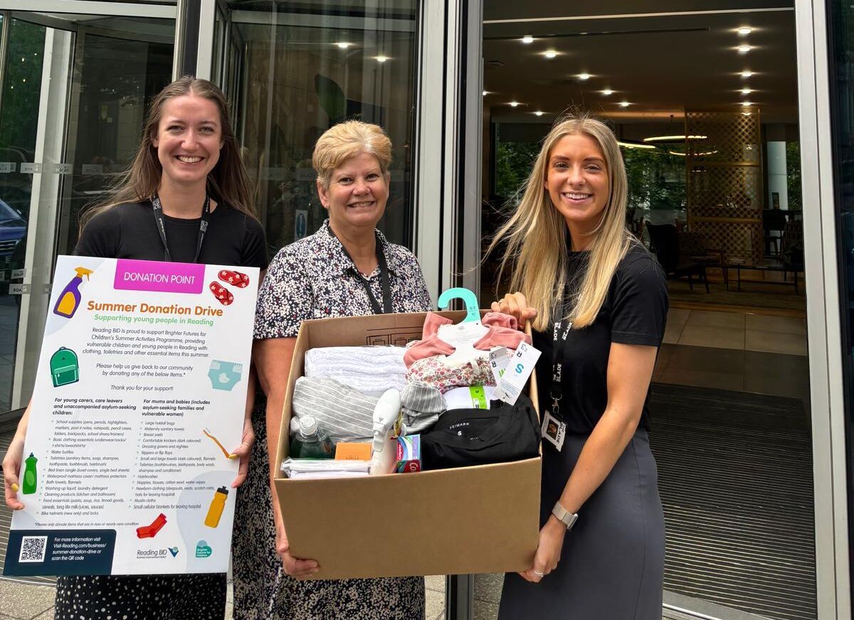 Staff carying boxes of donations